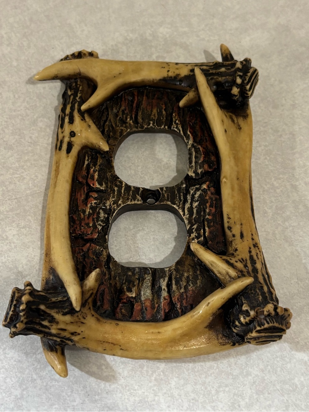 Molded plastic electrical outlet cover- antlers motif